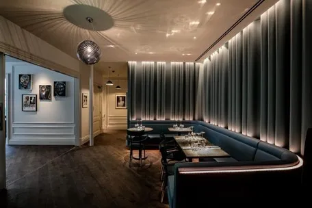 a dimly lit restaurant with a long table
